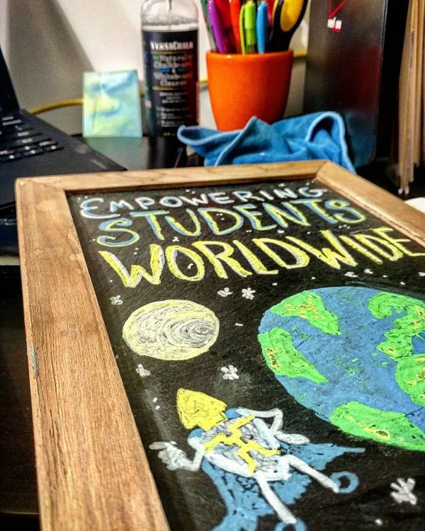 Chalkboard: Empowering Students Worldwide, with a rocket and a planet.