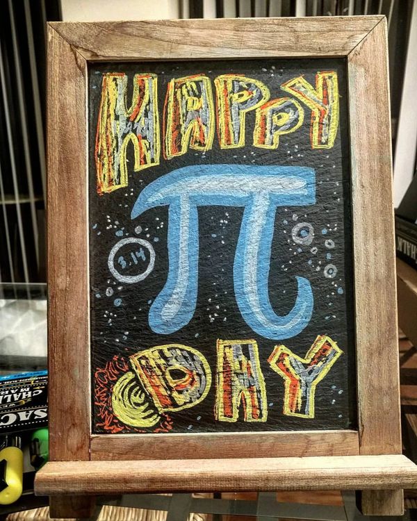 Chalkboard: Happy Pi Day, with a giant blue pi.