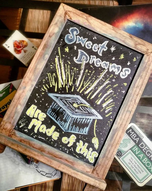 Chalkboard: Sweet dreams are made of this, with a graduation cap and fireworks.